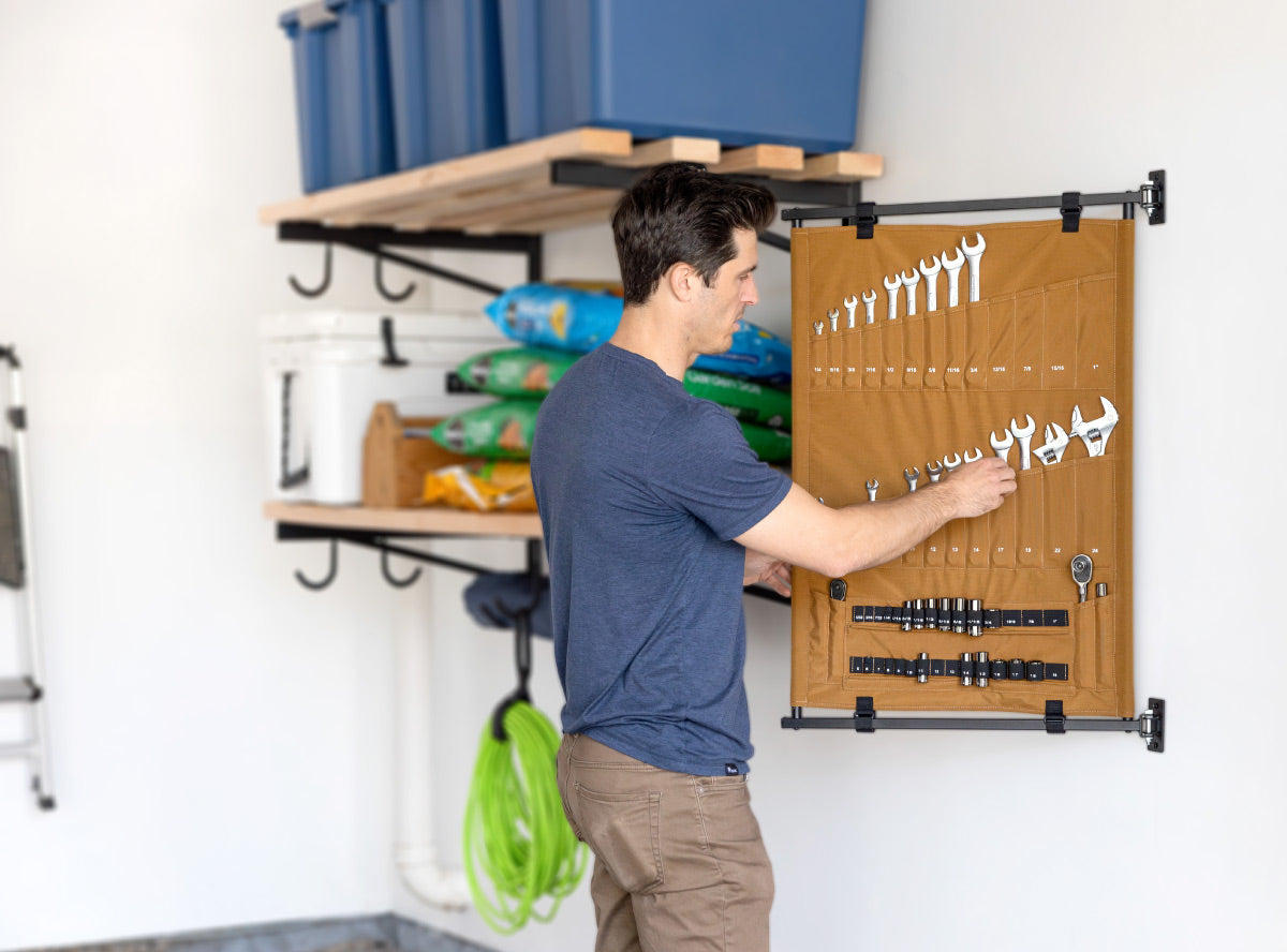 Wall mounted swiveling canvas with double-sided hand-tool storage